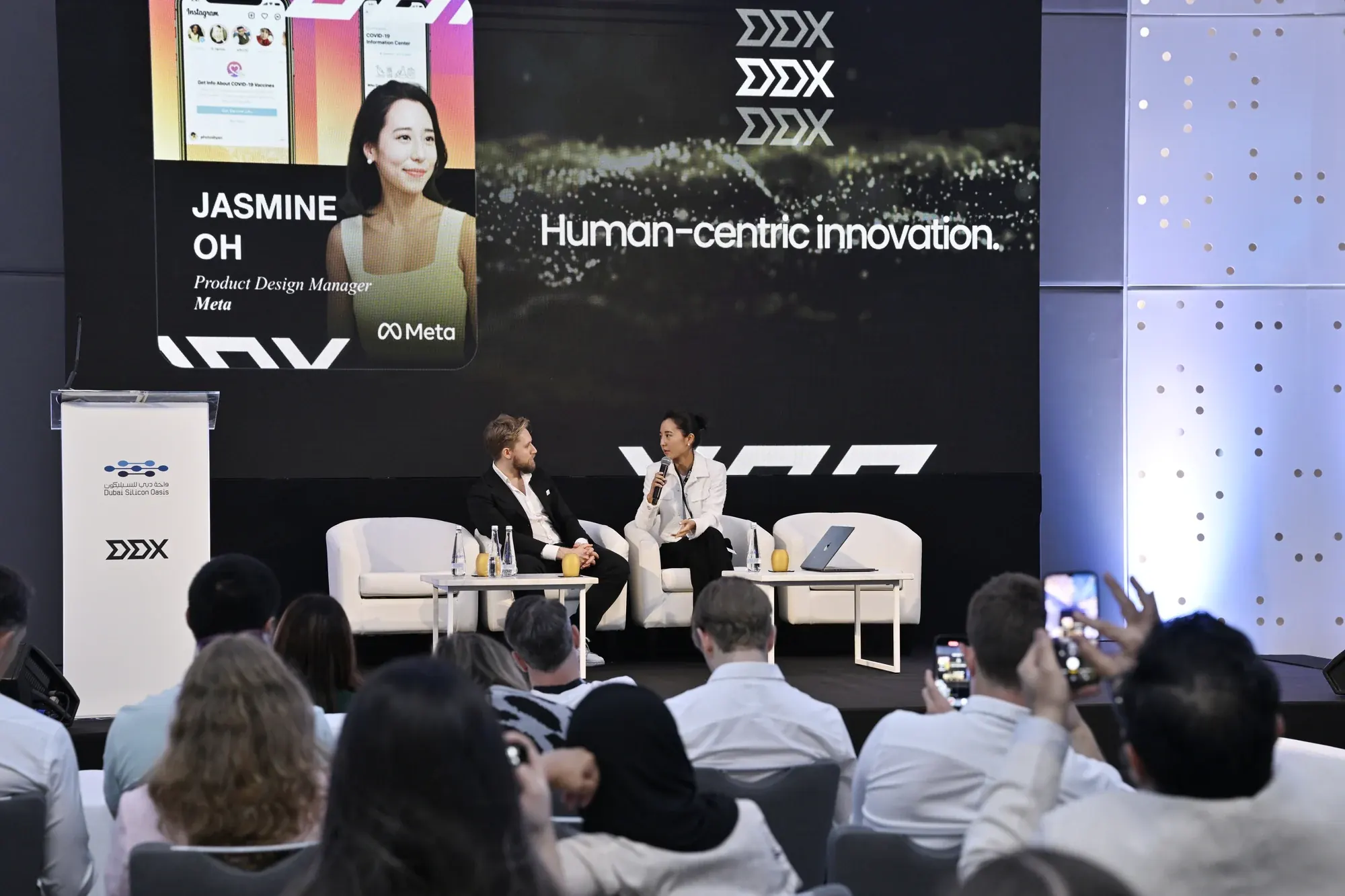 Jasmine Oh on stage at the DDX UX and Innovation Conference in Dubai, in conversation with a moderator